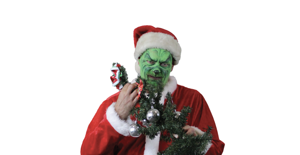 Grinch in Santa costume with decorations.