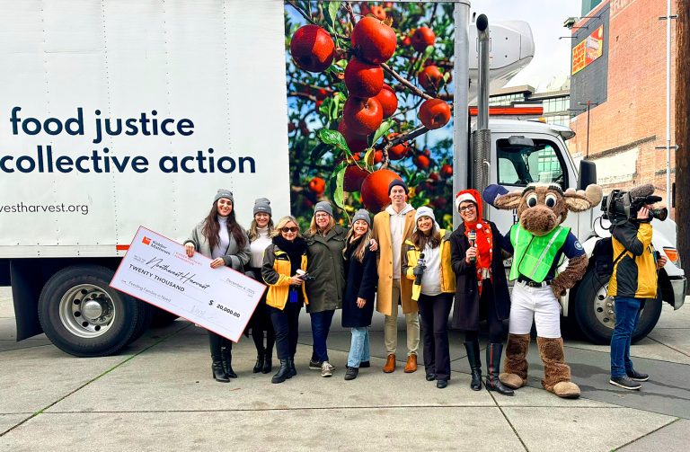 Kidder Mathews employees with oversized check and mascot