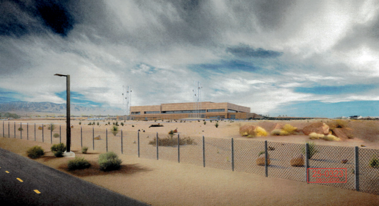 Desert landscape with fenced building Red Rock Communications Center.