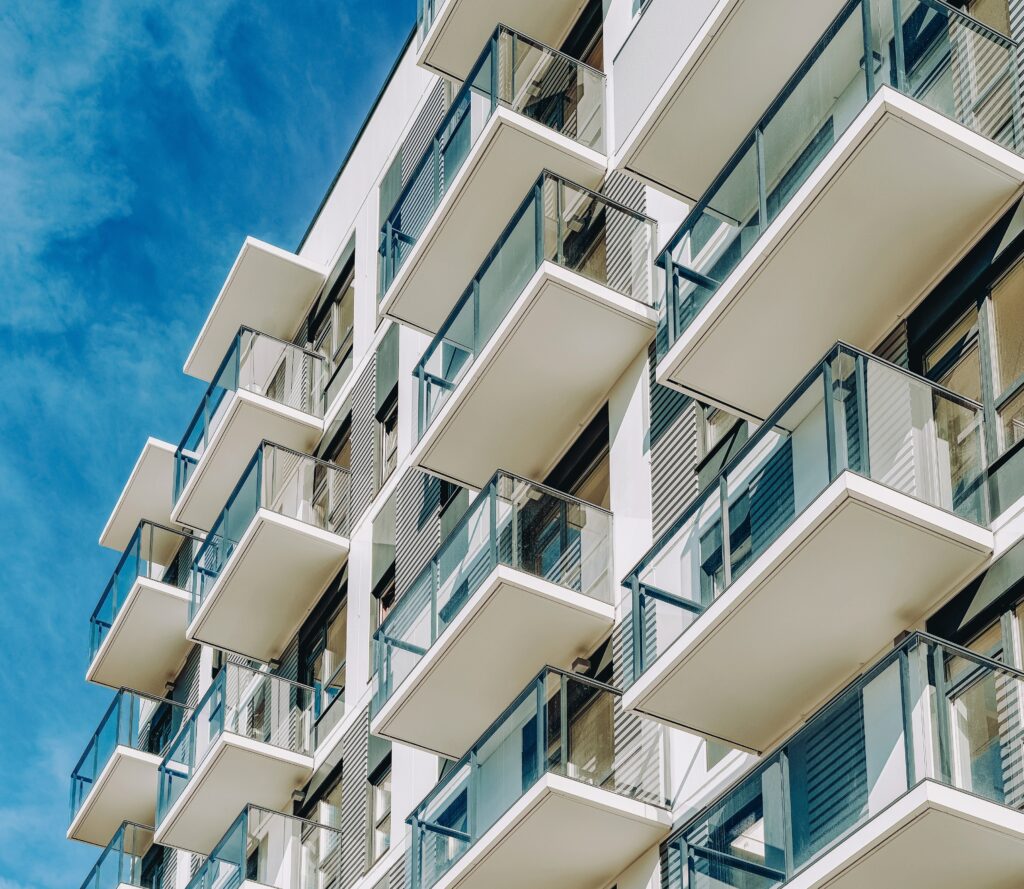 Detail of Modern residential apartment flat building exterior. Fragment of New luxury house and home complex. Part of City Real estate property and condo architecture with a blue sky