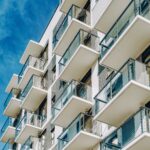Detail of Modern residential apartment flat building exterior. Fragment of New luxury house and home complex. Part of City Real estate property and condo architecture with a blue sky