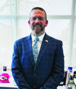Headshot of Casey Gunther in a suit