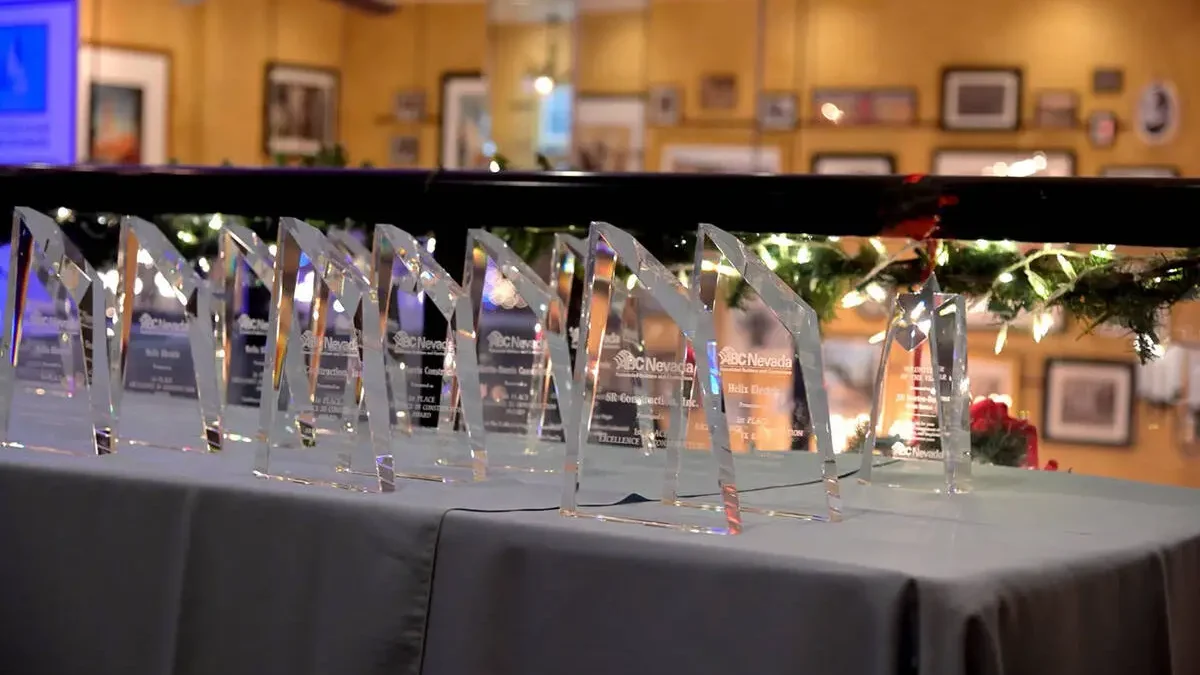 Row of Excellence in Construction crystal awards on table